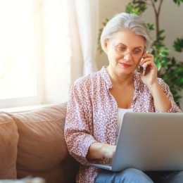 Older woman on laptop and phone call
