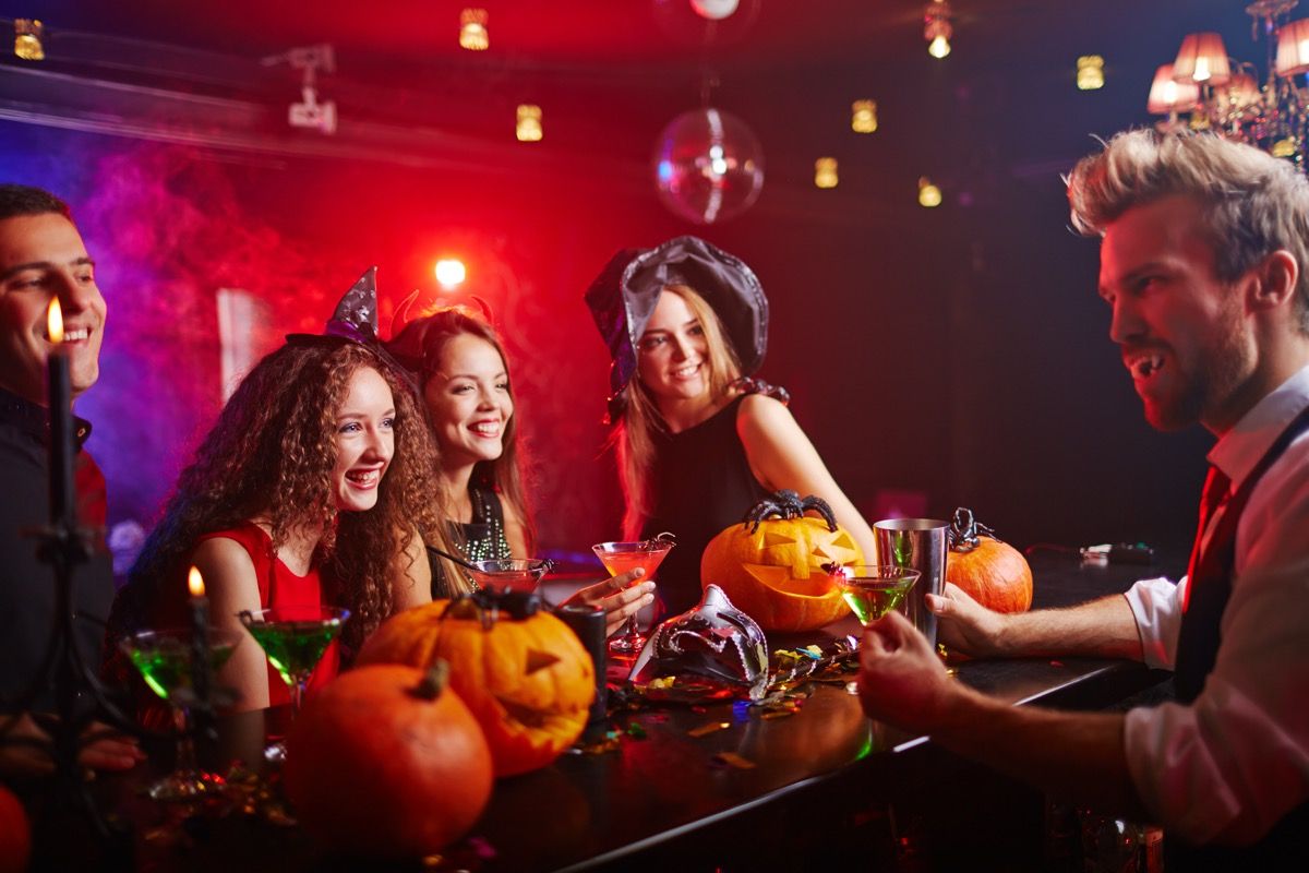 people sitting at a bar in halloween costumes things to throw away 