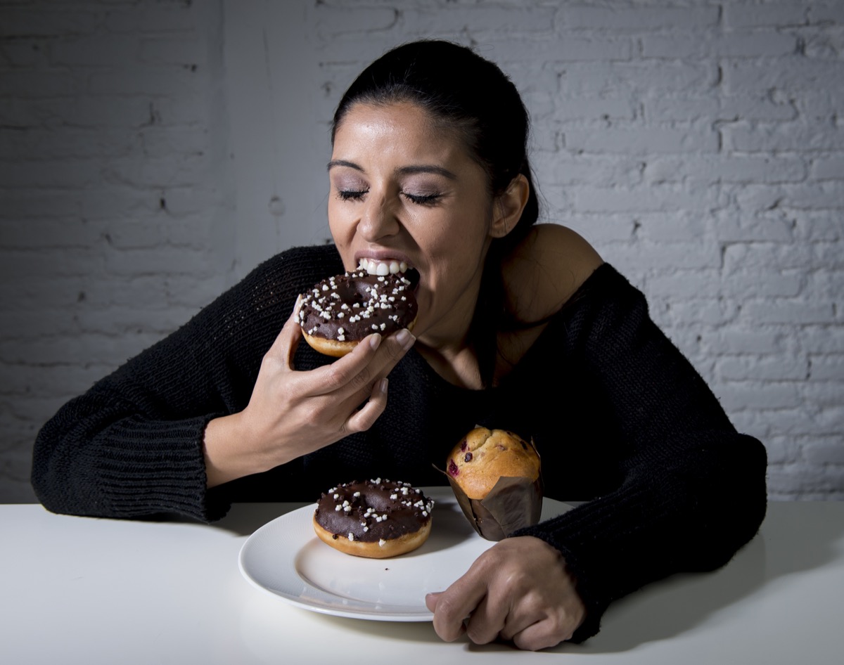 Woman eating donuts