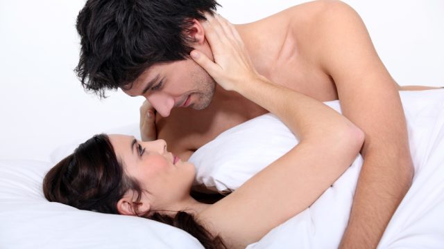 couple in bed stares lovingly into each other's eyes thanks to midnfulness