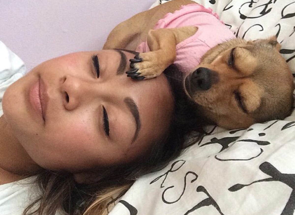 woman and her dog sleeping dogs who look like their owners