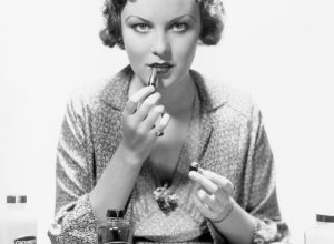 woman applying makeup old beauty products