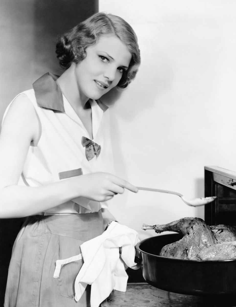 Vintage Photo of a Woman in the Kitchen Cooking a Chicken {Dating 50 Years Ago}