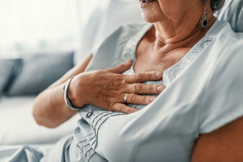 Older woman experiencing heartburn