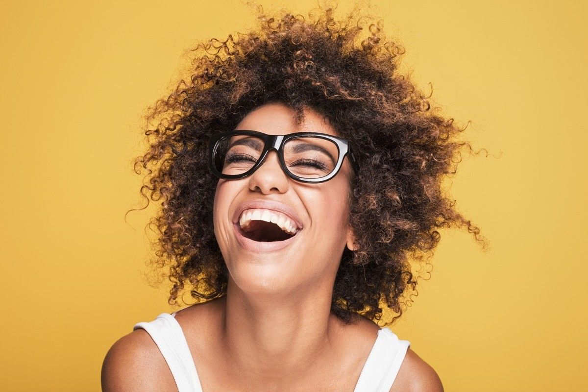 woman laughing on gold background, what do you call jokes