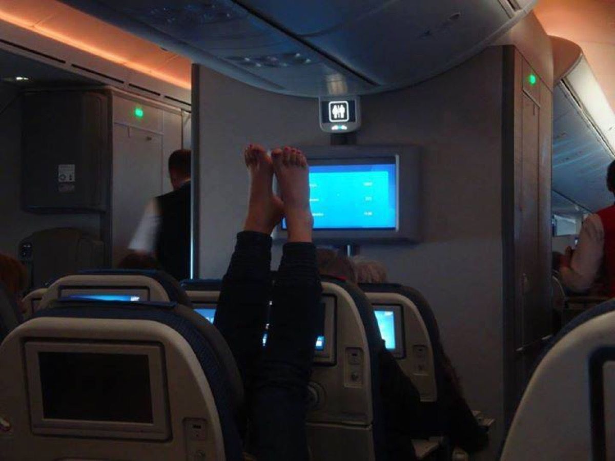 Woman with feet up on airplane photos of terrible airplane passengers