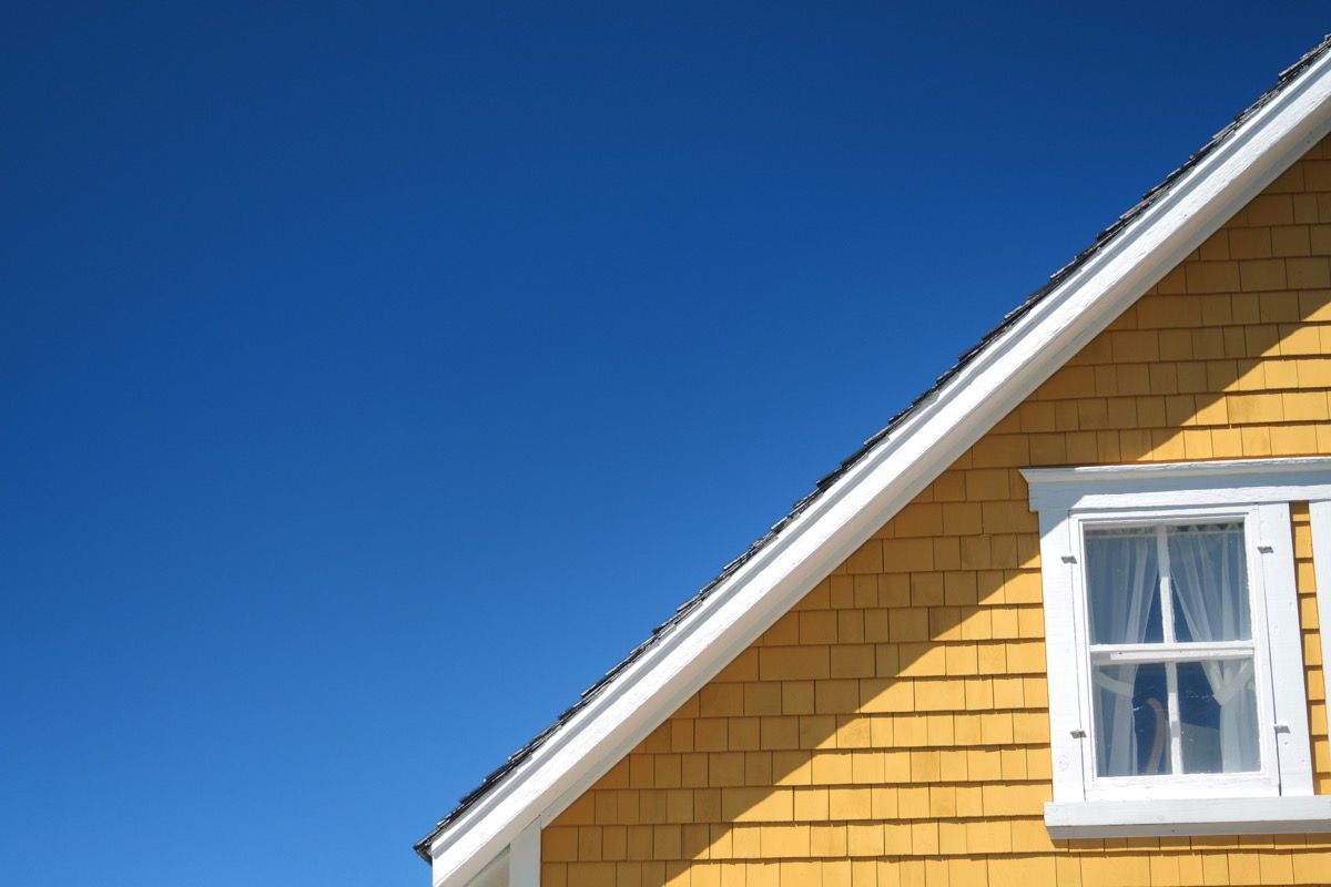 yellow home exterior which part of the roof shown