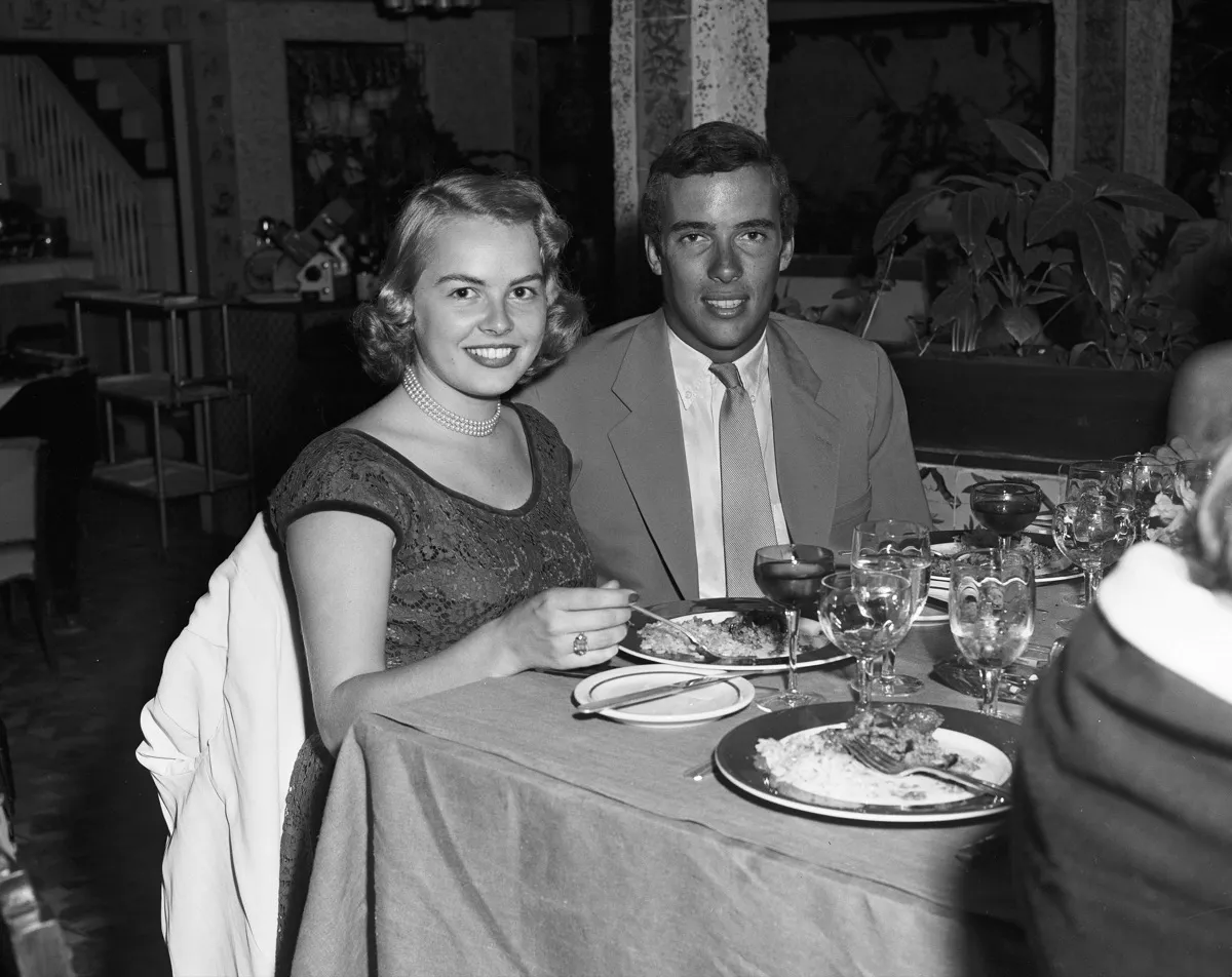 1950s couple eating fancy dinner at nice restaurant, big date