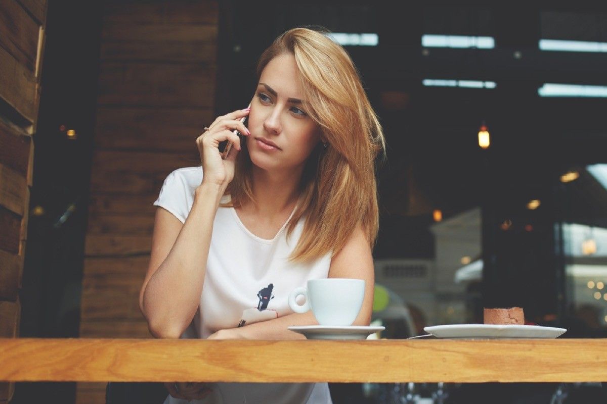 stressed out woman taking a phone call, working mom