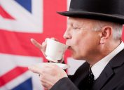 british man drinking tea with flag british words