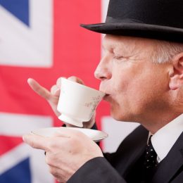 british man drinking tea with flag british words