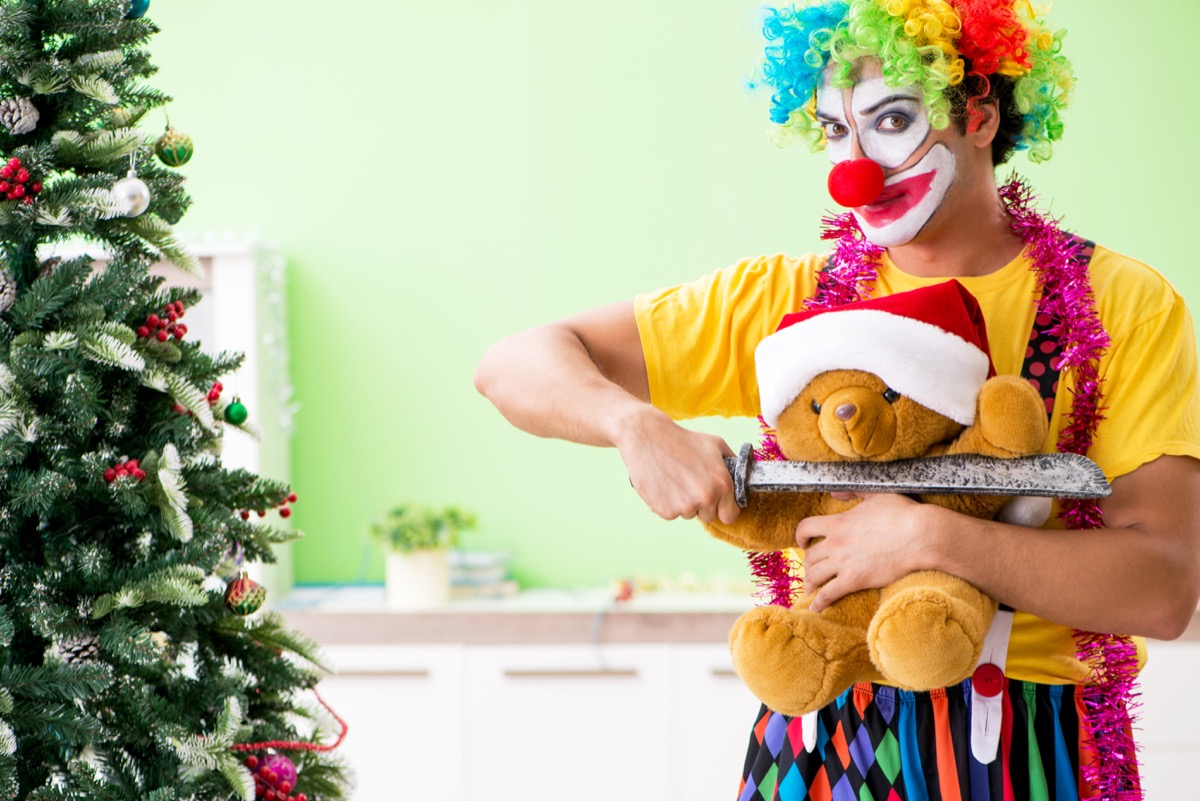 Clown Threatening a Teddy Bear on Christmas Funny Stock Photo