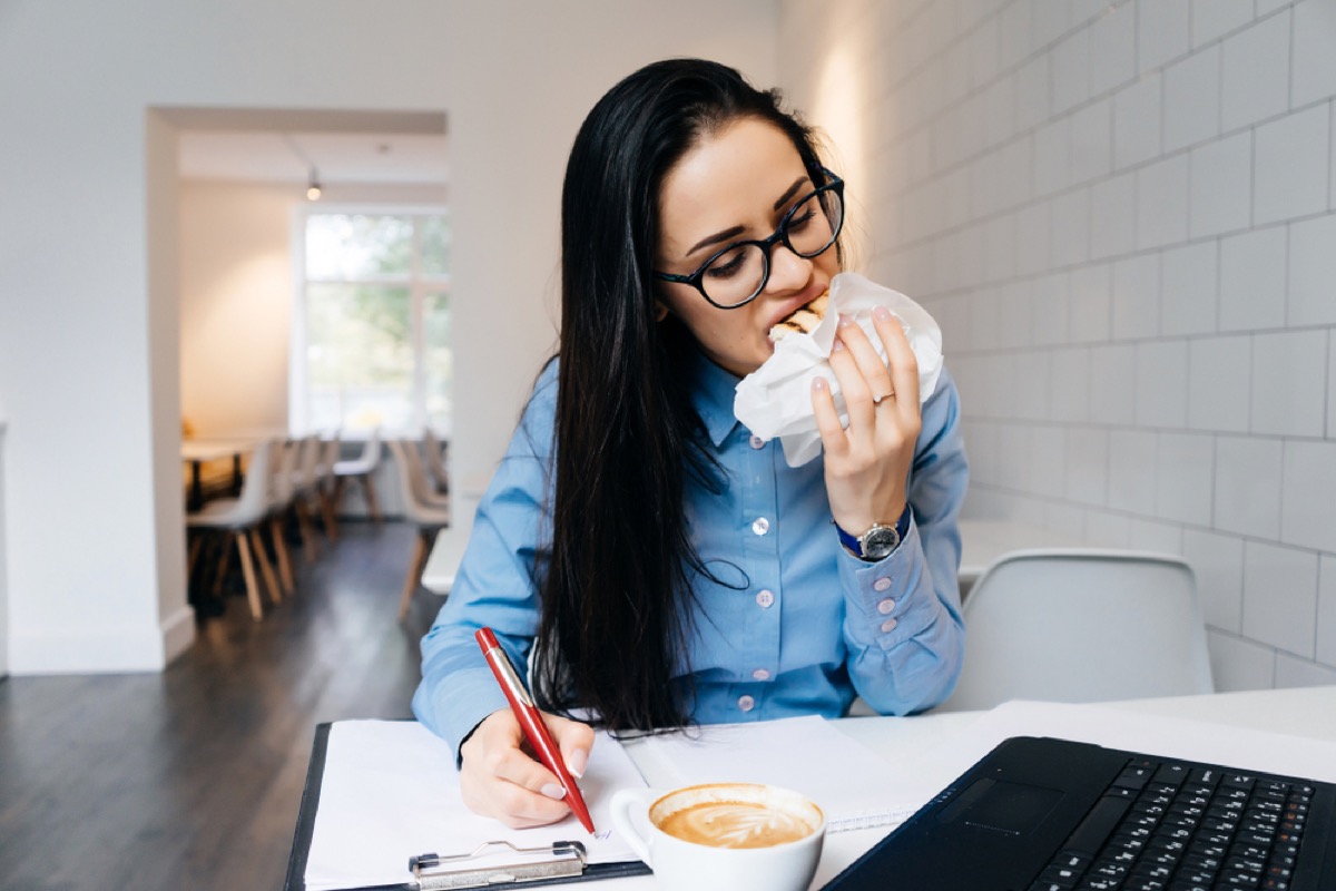 woman eating while working, working mom