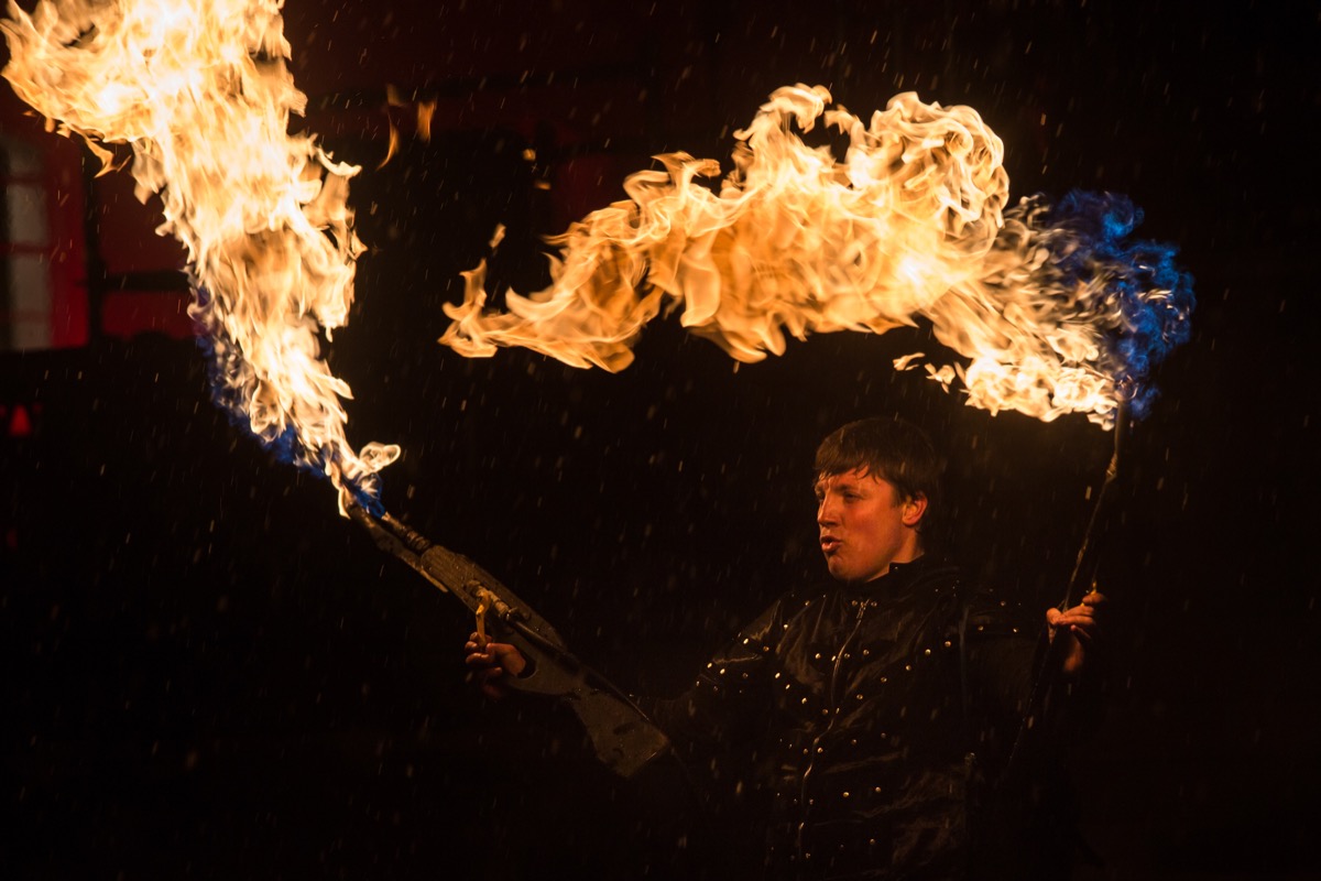 man holding two flamethrowers, old inventions