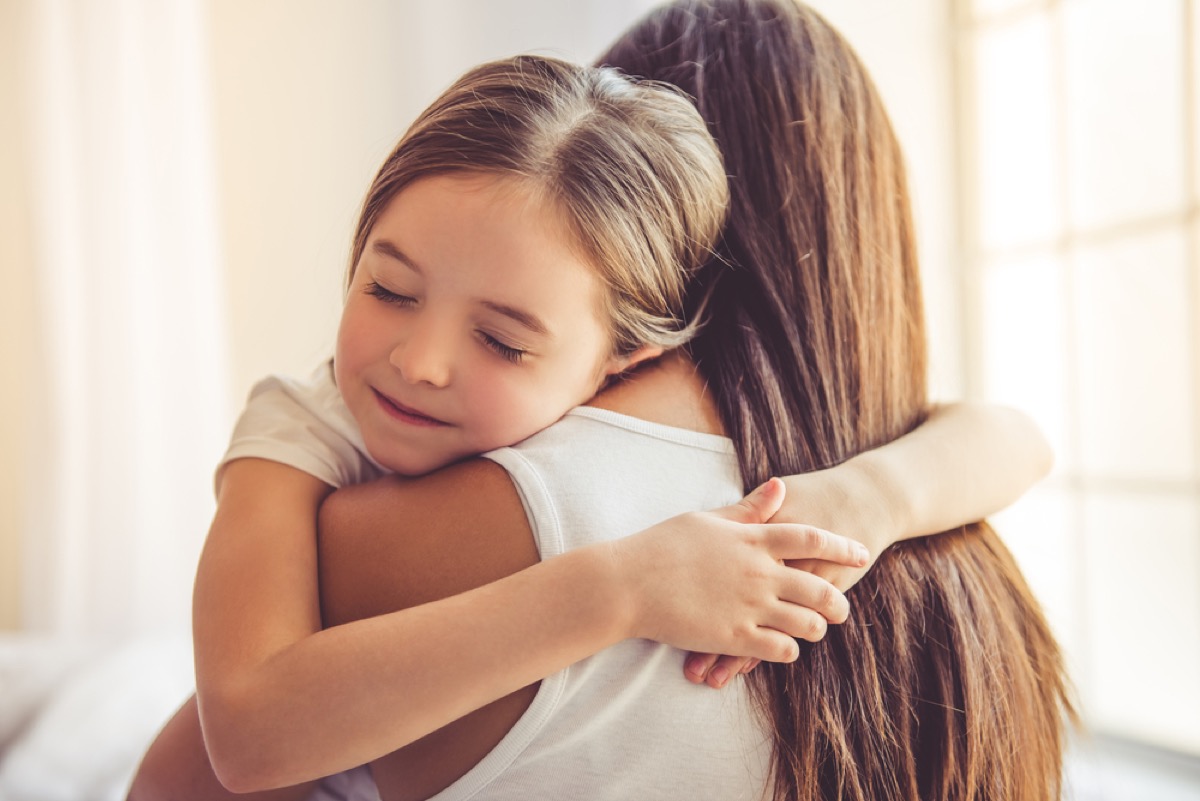 young girl hugging her mother, parenting myths