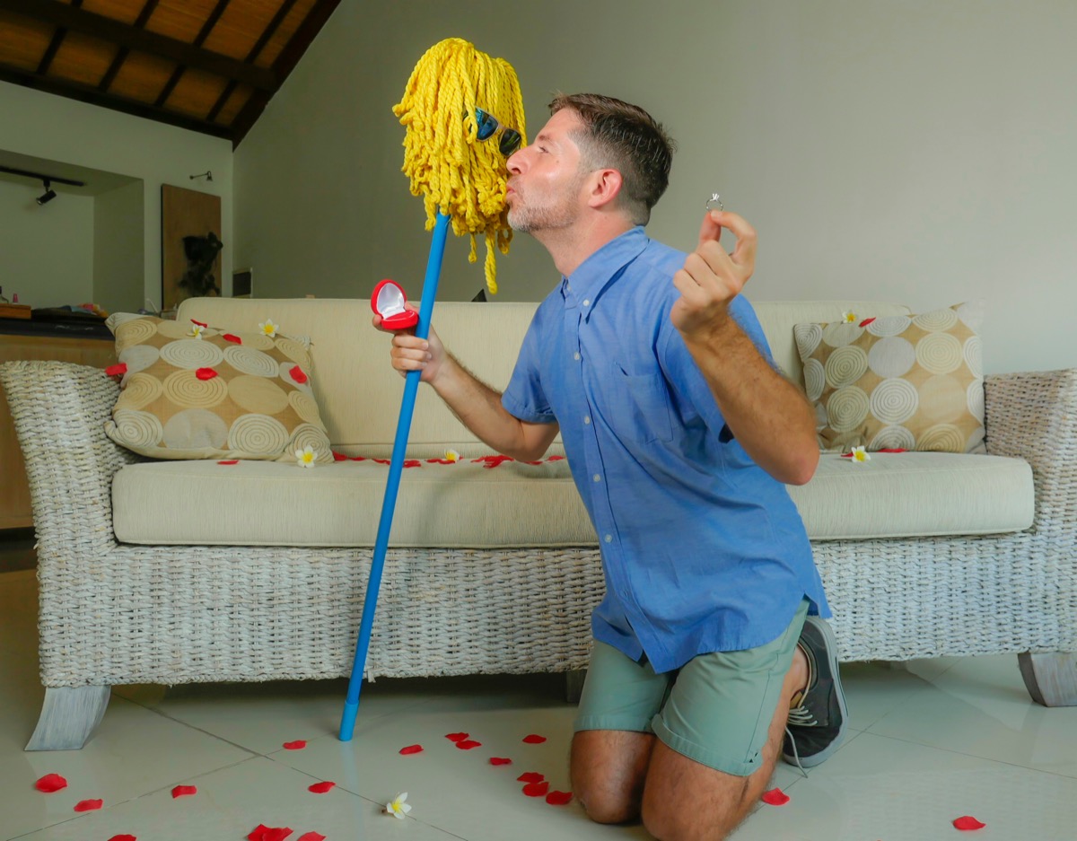 Man proposing to his broom Funny Stock Photos