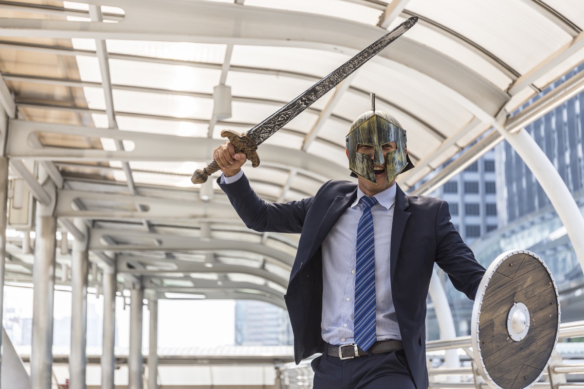 Man With a Sword and Shield in the Office Funny Stock Photos