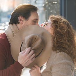 man and woman kissing in the street