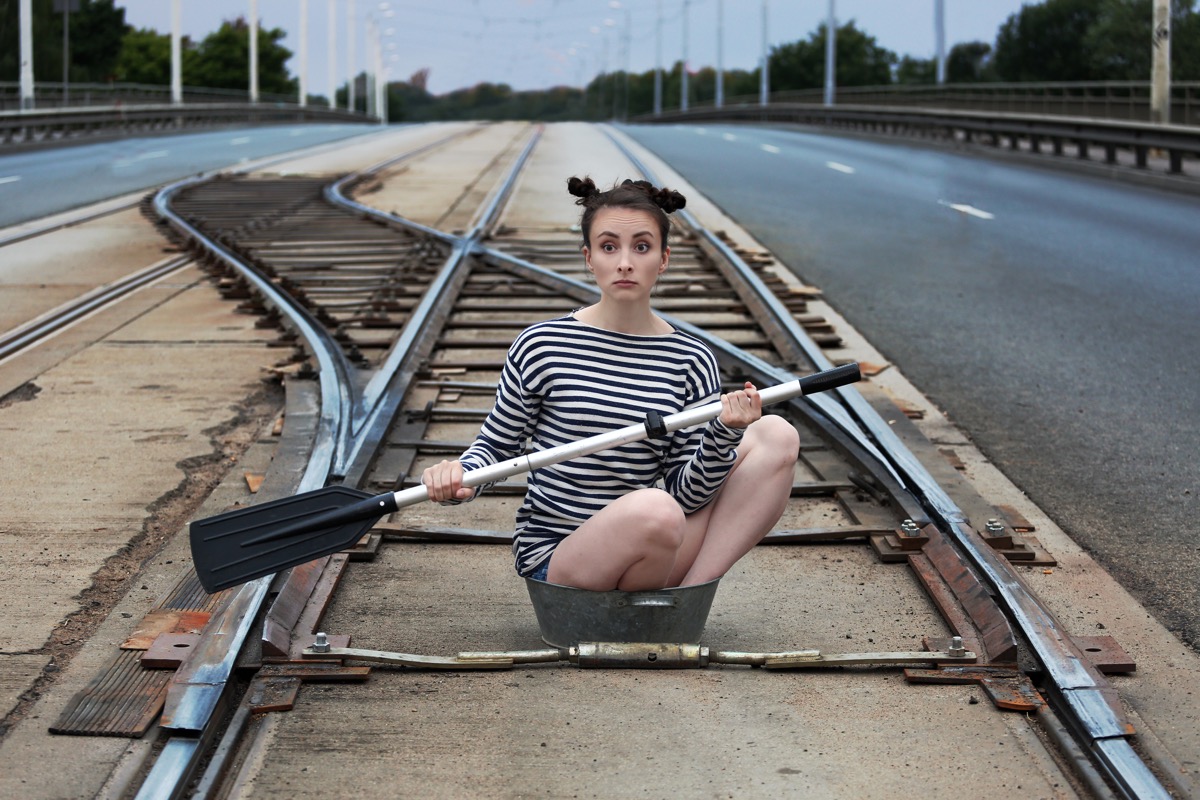 Woman Rowing a Boat Down Train Tracks Funny Stock Photos