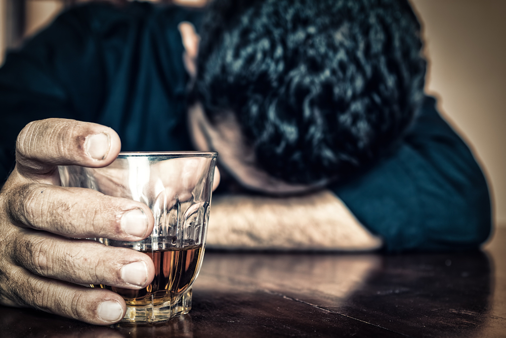 depressed man drinking whiskey