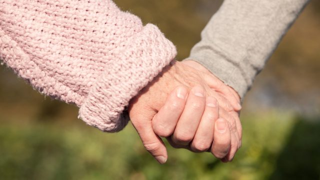 elderly couple holding hands, healthy sex after 40