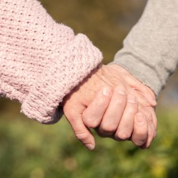 elderly couple holding hands, healthy sex after 40