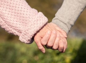 elderly couple holding hands, healthy sex after 40