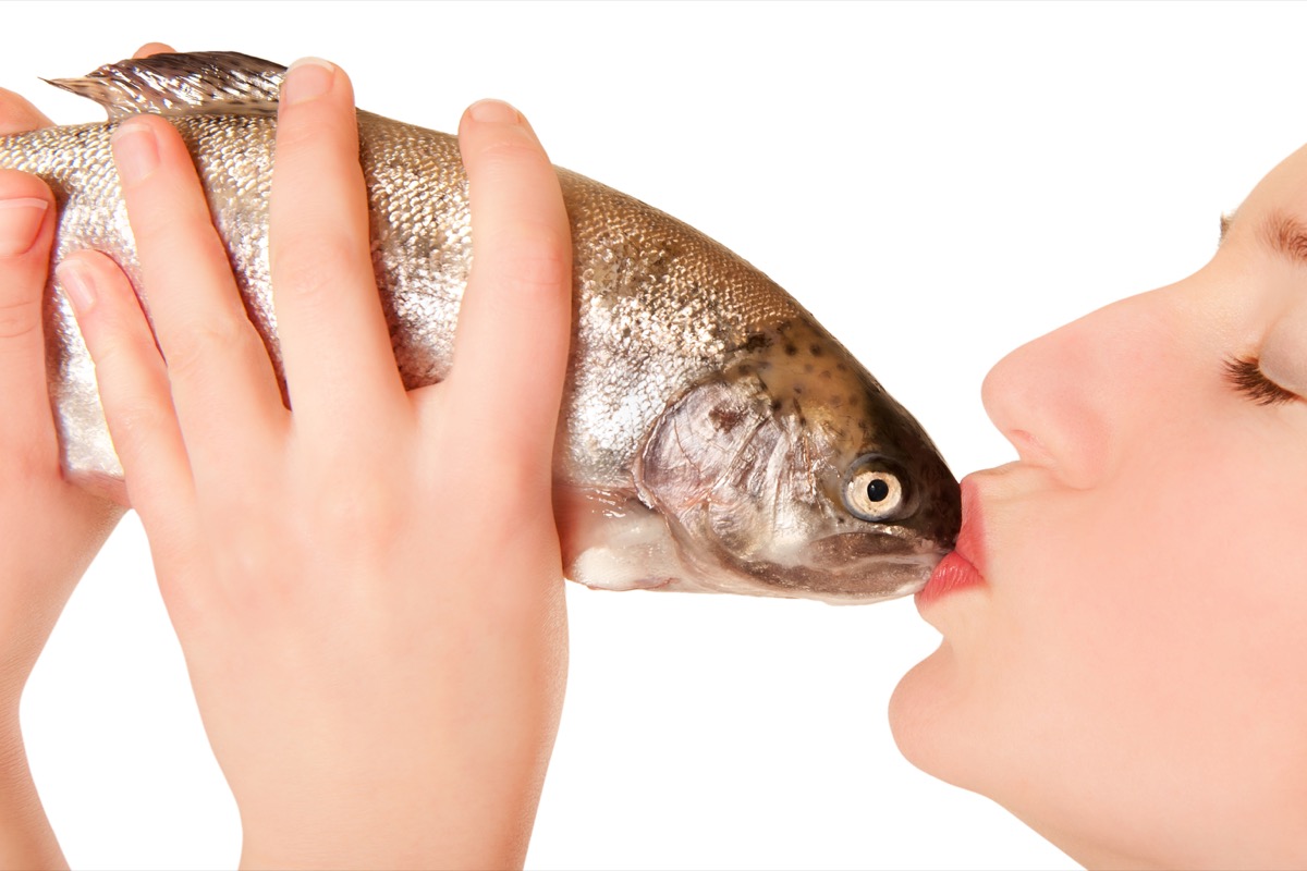 Woman Kissing a Fish Funny Stock Photos