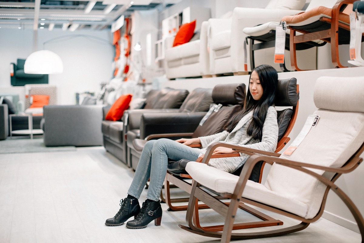 woman at furniture store sitting in seat