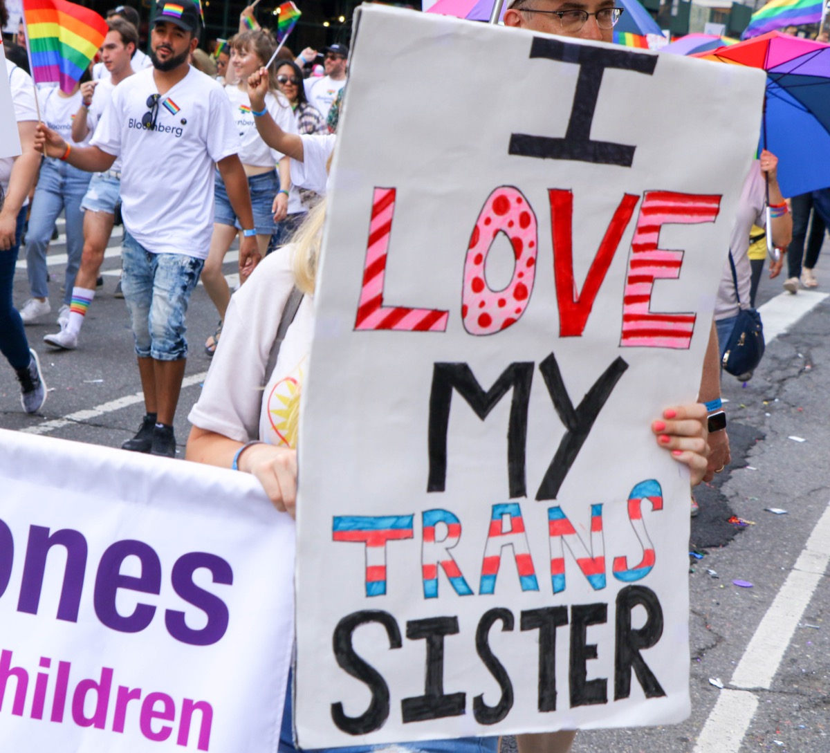 woman hold sign supporting trans sister at new york city pride photos from pride celebrations