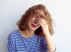 woman laughing to herself