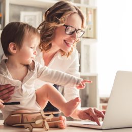 mom holding baby while working on laptop, prepare children for divorce