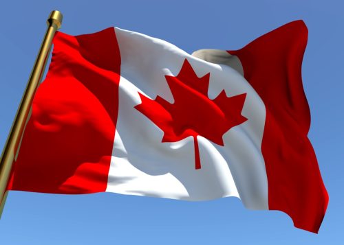 Canadian Flag blows in wind, Canadian traditions Americans should adopt