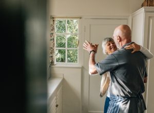 Mature couple dancing in their home