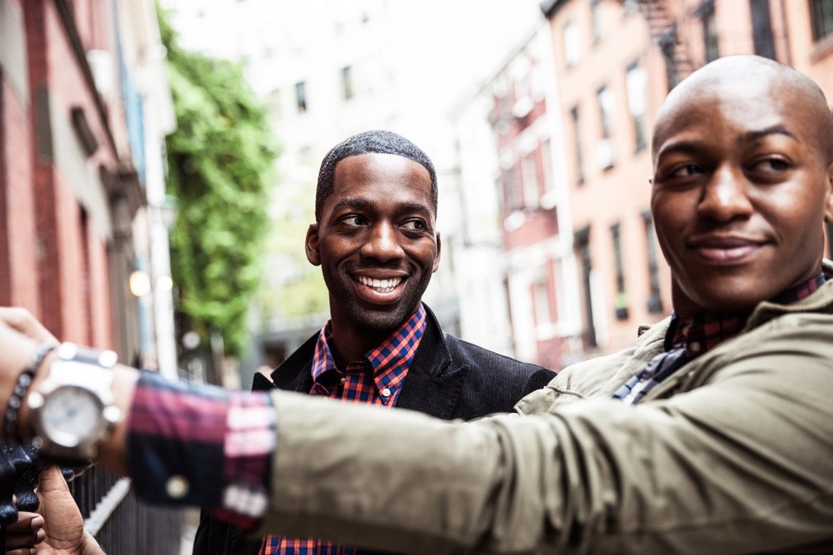 Homosexual young couple hanging out and relaxing on the streets in Greenwich Village - New York, USA.