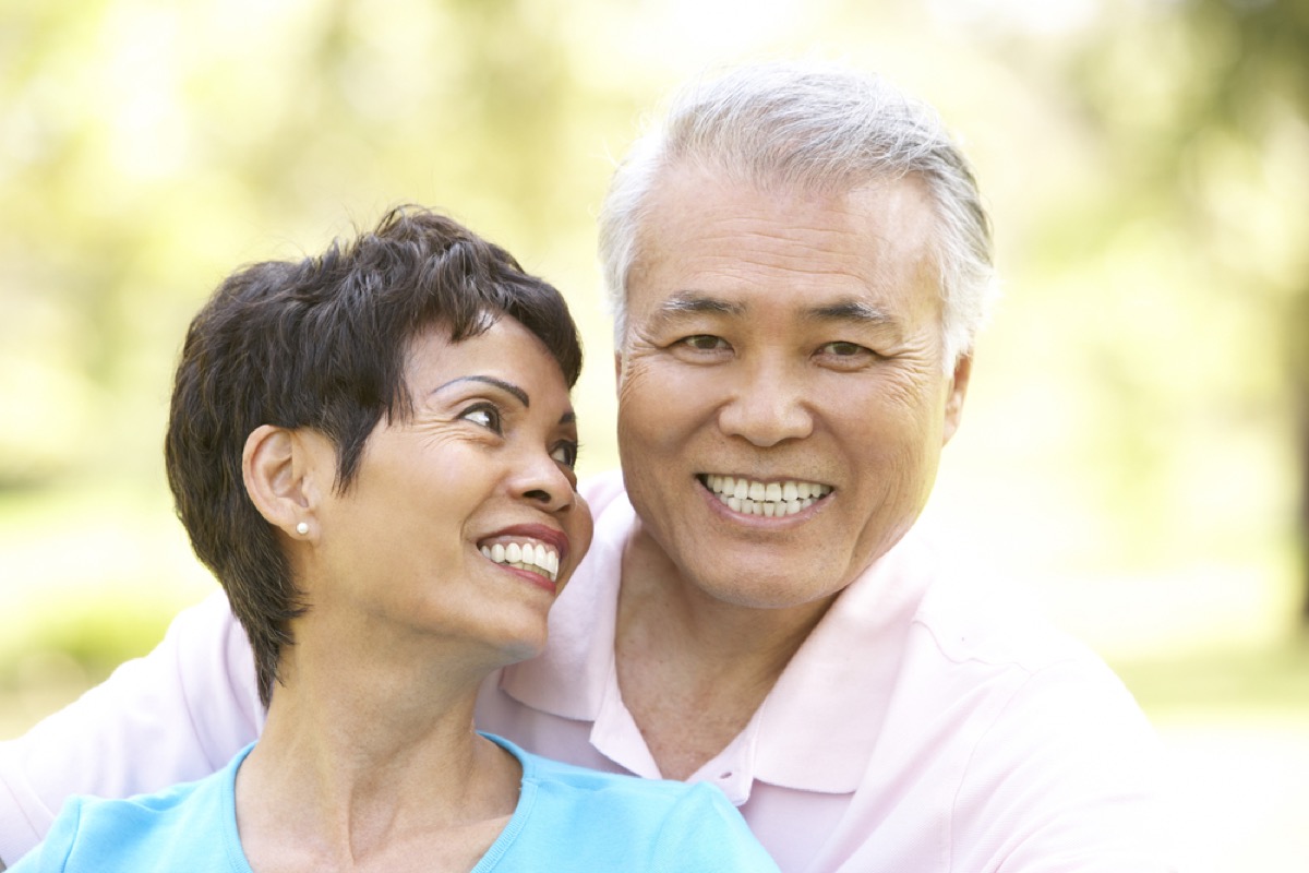 older couple being affectionate outdoors, long marriage tips