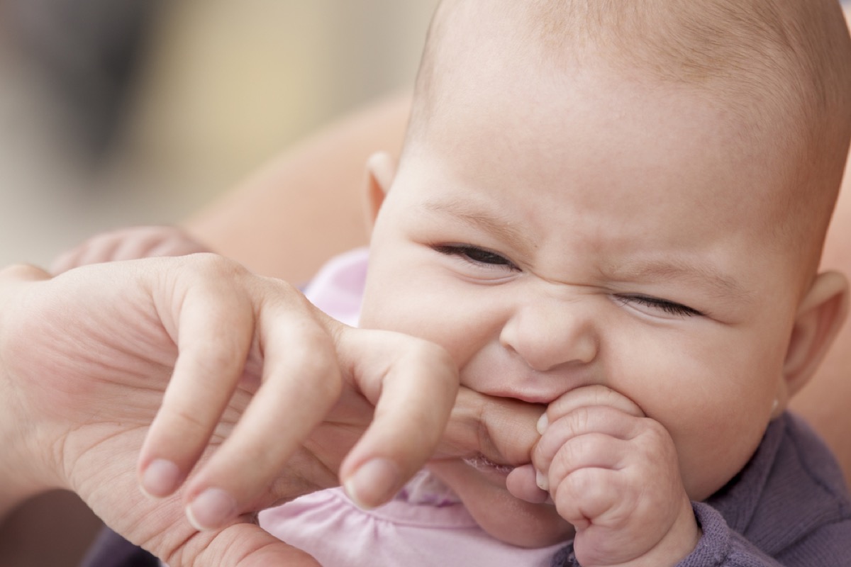 baby biting her mother's finger, bad parenting advice