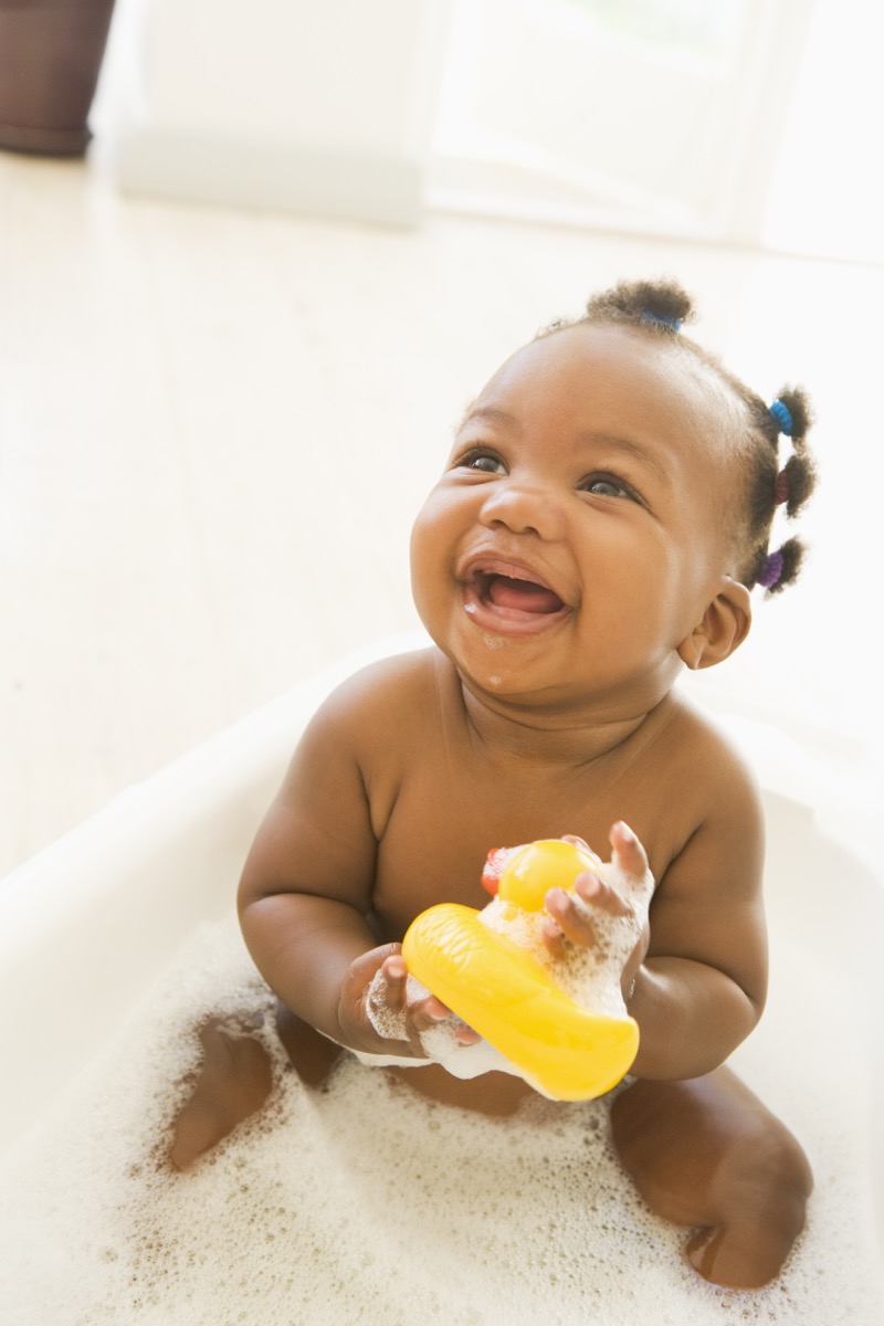 baby in a bath with rubber duckie