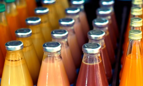 Vibrant Bottles of Juice Lined Up, Close-Up