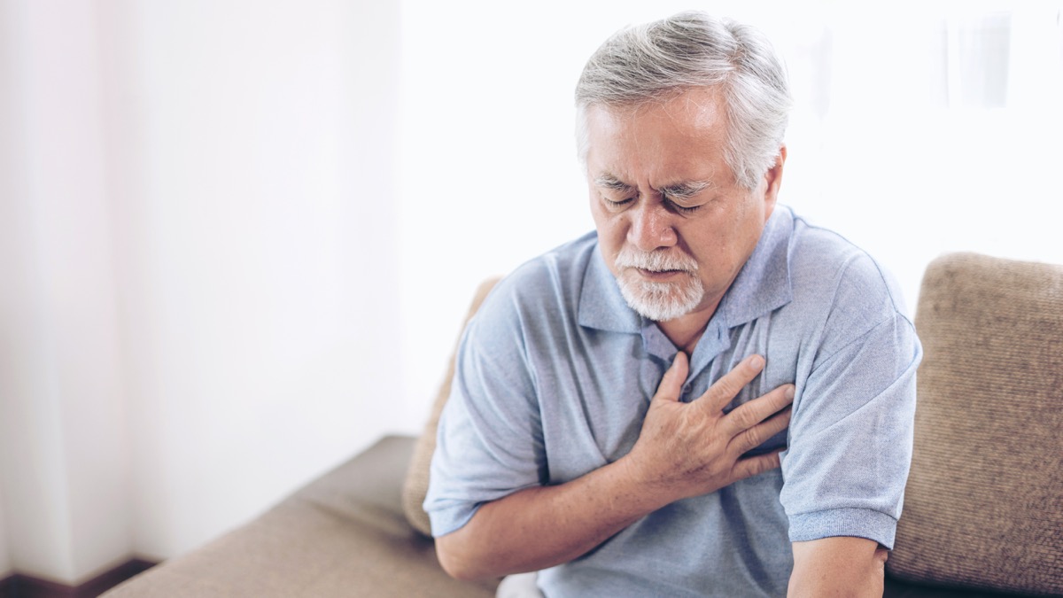 heartburn or chest pain for a man clutching his chest