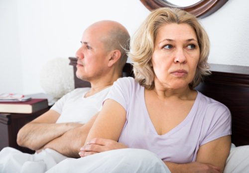 older couple fighting in bed, over 50 regrets