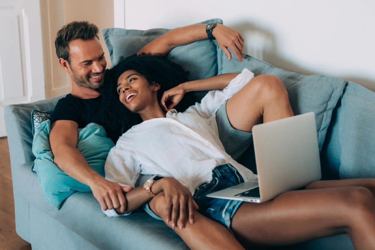 happy interracial couple cuddling, things you shouldn't say about someone's body