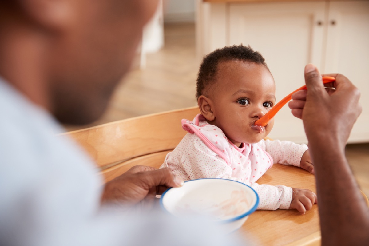 father feeding baby daughter, parenting myths
