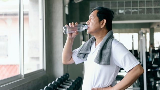 old man drinking water after exercising, ways to feel amazing