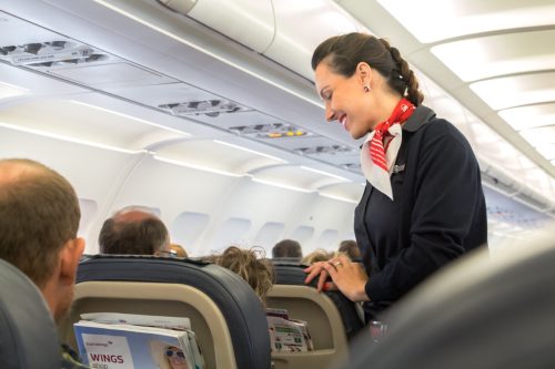 flight attendant talking to man