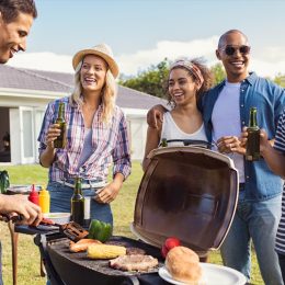 Friends Hanging Out by the Grill at a Barbecue BBQ Etiquette Mistakes