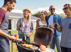 Friends Hanging Out by the Grill at a Barbecue BBQ Etiquette Mistakes