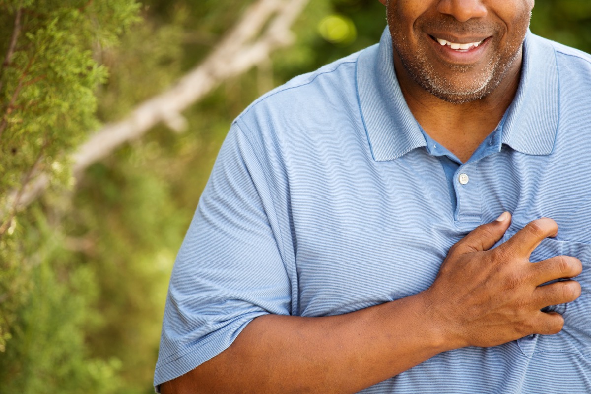 black man puts hand on chest due to acid reflux, things that would horrify your dentist