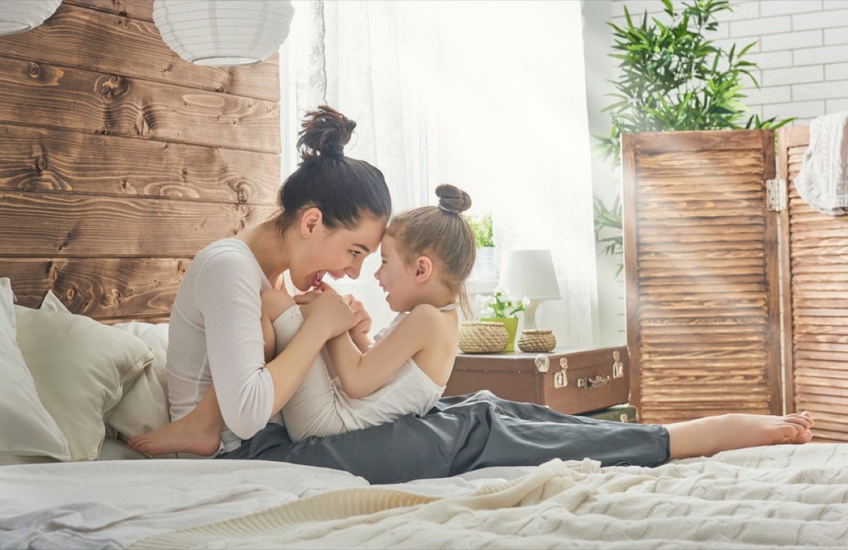 happy mother with child in bed, parenting myths