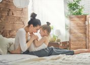 happy mother with child in bed, parenting myths